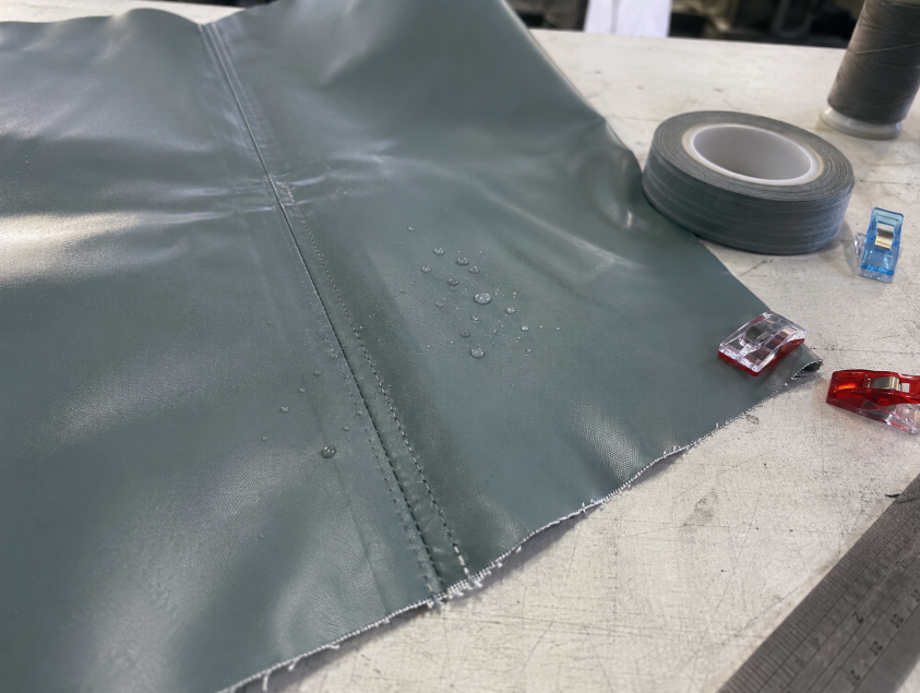 Waterproof fabric seam detail showing coated material, stitching, seam tape, and potential water entry points