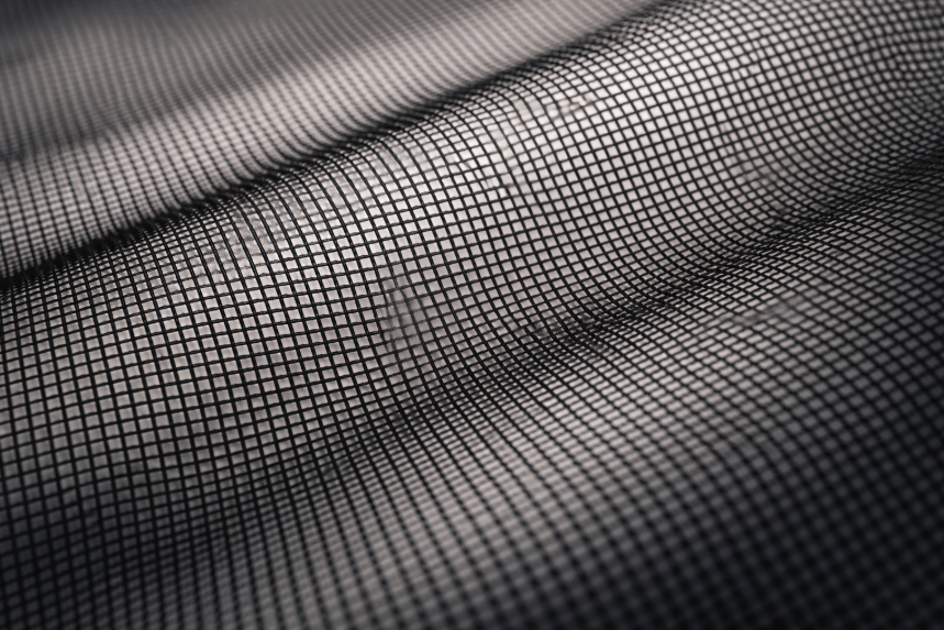 Close-up of black noseeum netting showing a fine insect-blocking mesh weave with visible airflow openings.