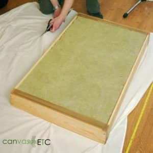 Stretching and stapling acoustic fabric