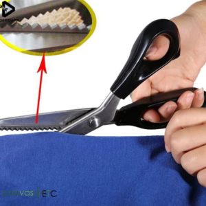 Pinking shears cutting fabric