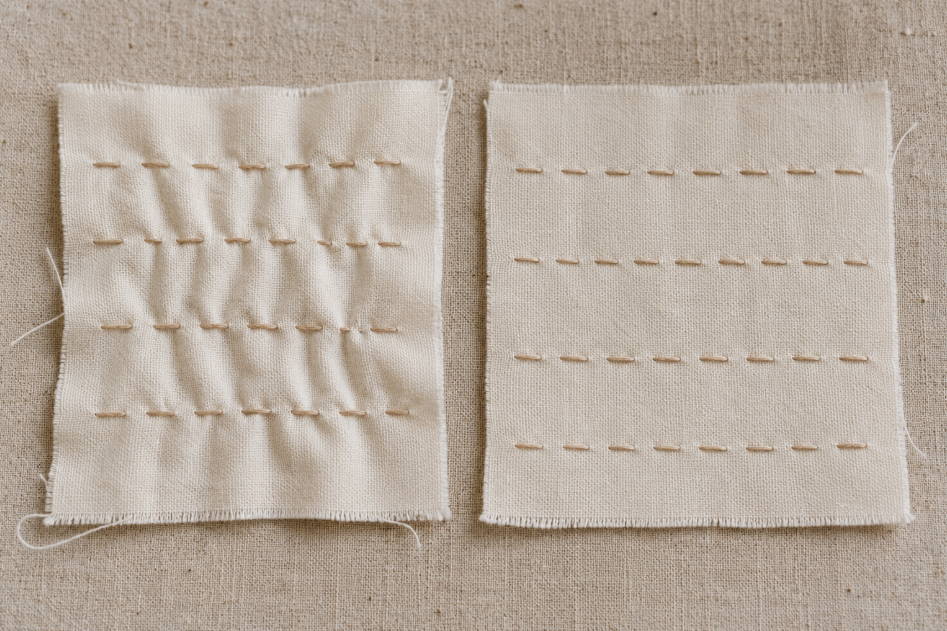 Slow stitching tension comparison showing puckered fabric beside smooth hand stitches on cotton fabric