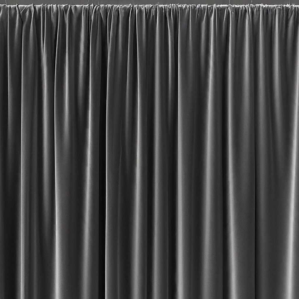 Close-up of black velvet drape hanging on pipe and drape system