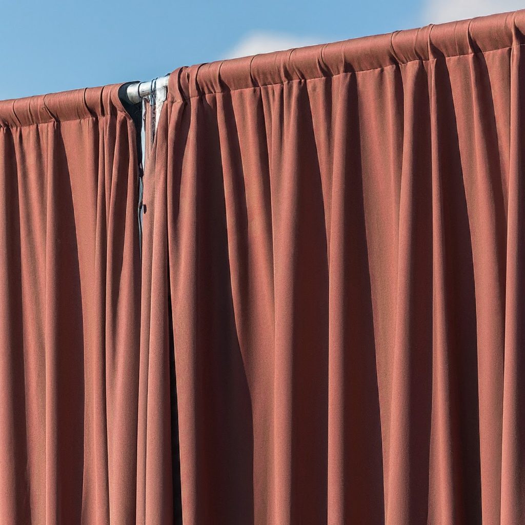 Weather-resistant pipe and drape fabric used for outdoor events
