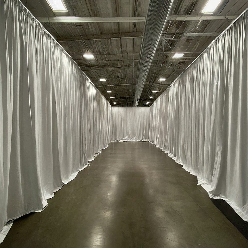 Pipe and drape used to divide a large open space into smaller functional areas