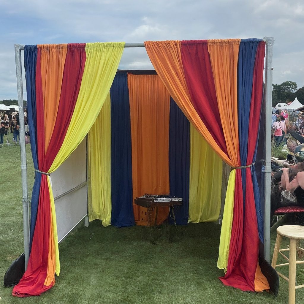 a finished pipe and drape dressing room setup at an event