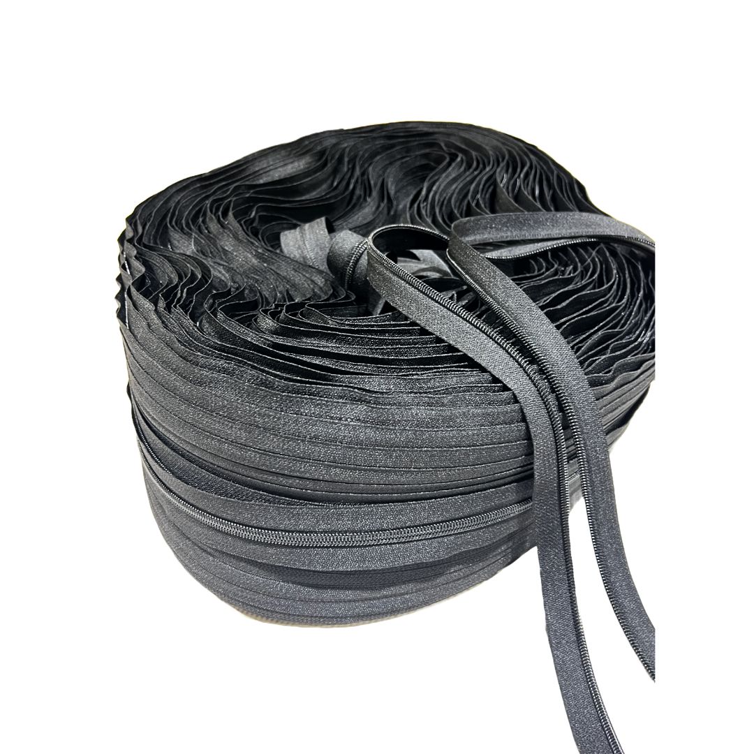 Close-up view of #5 black zipper coil teeth – flexible, high-quality nylon zipper tape for sewing projects.