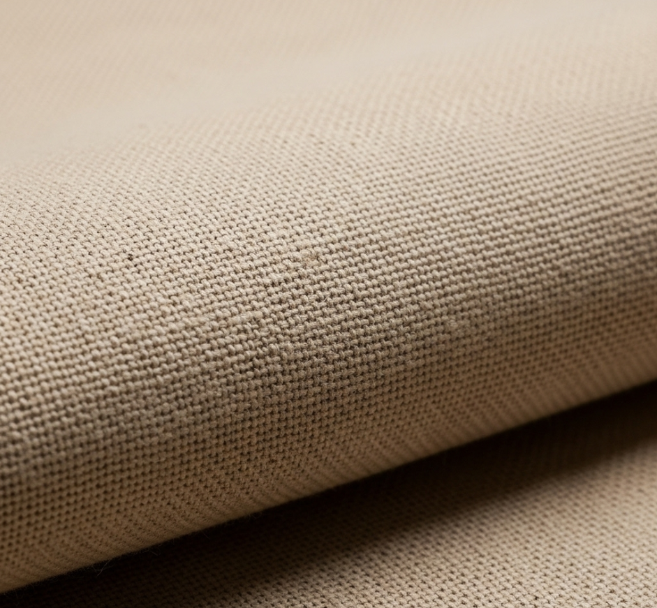 A detailed close-up shot of raw unprimed cotton duck canvas, highlighting the natural weave and earthy texture that embodies the wabi-sabi principle of imperfect beauty.